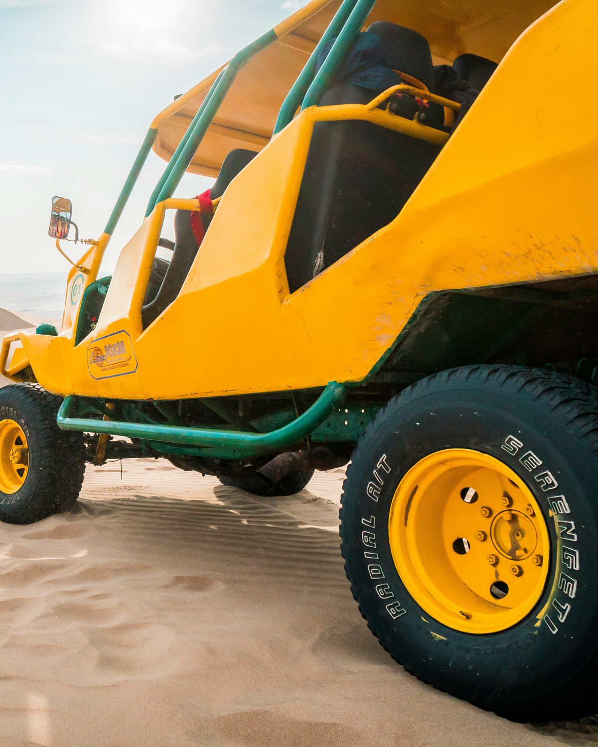 Yellow buggy parked on sand dunes in Arraial do Cabo, an exciting activity to explore unique natural landscapes, perfect for adventurers looking for things to do in the region.